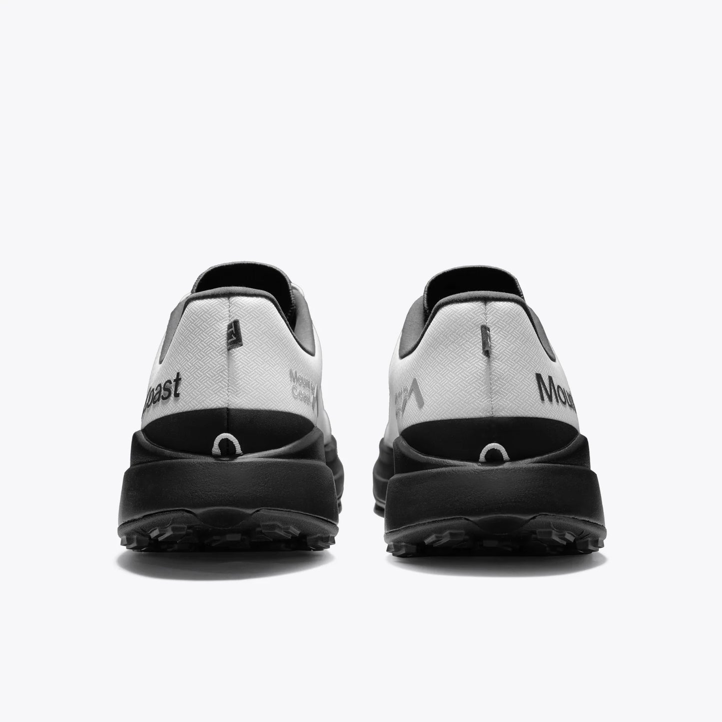 Mount to Coast T1 trail running shoes rear view in white and black colorway. Showcasing the brand logo and design detail.
#Color_tephra