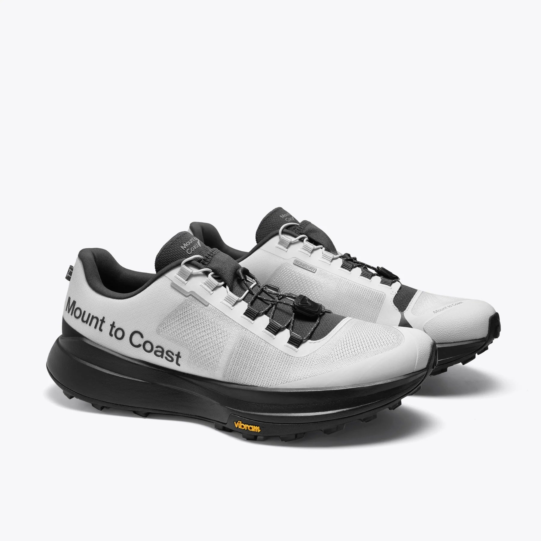 Mount to Coast T1 trail running shoes, white and black colorway, Vibram sole, for long-distance trail adventures.
#Color_tephra