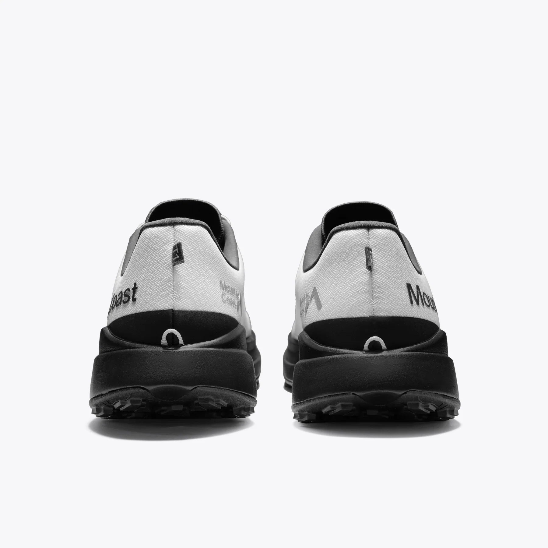 Mount to Coast T1 trail running shoes rear view in white and black colorway. Showcasing the brand logo and design detail.
#Color_tephra