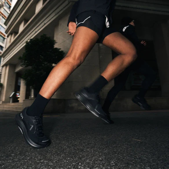 Runner wearing black Mount to Coast running shoes #Color_black